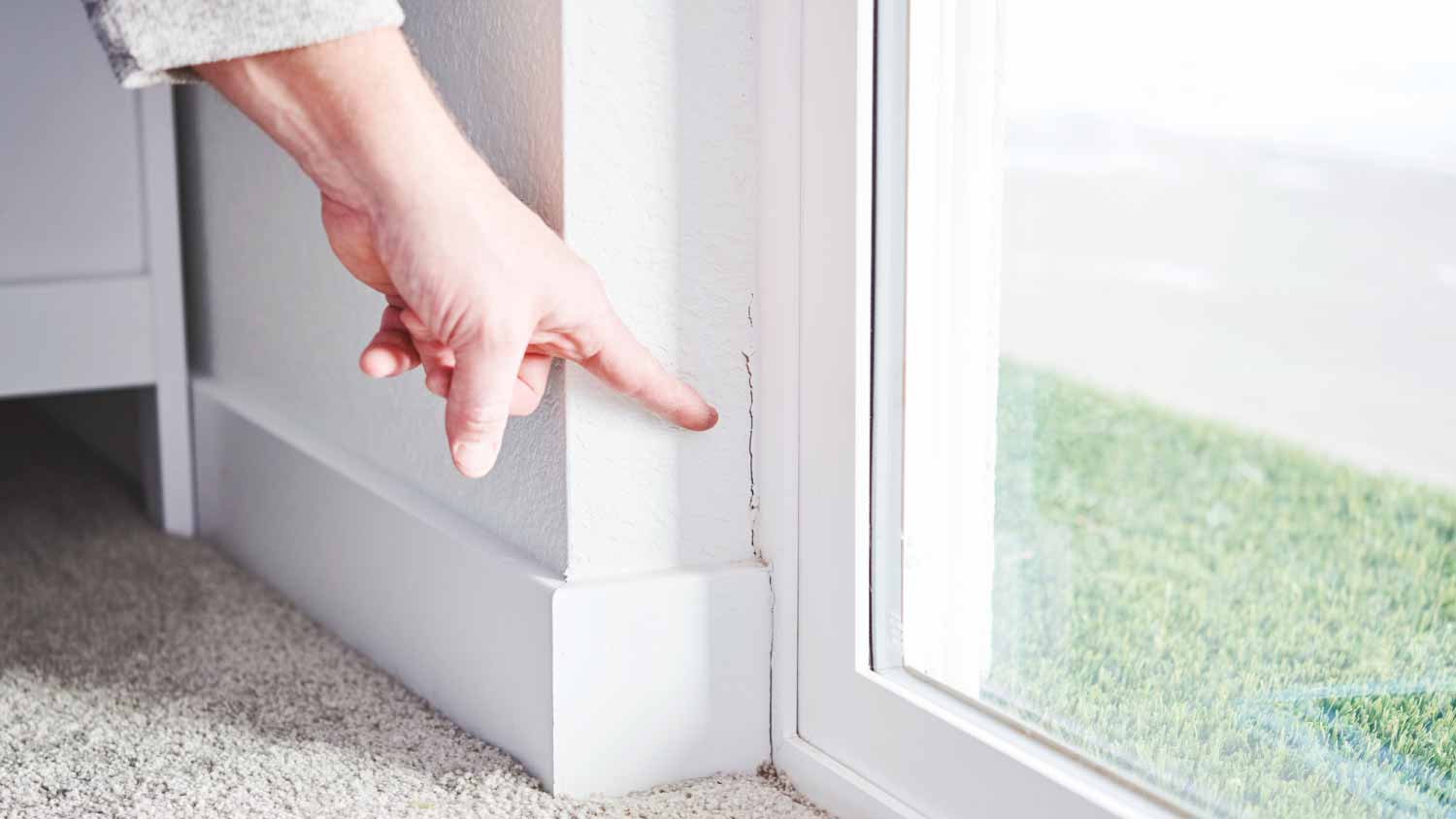 Inspector pointing at a crack