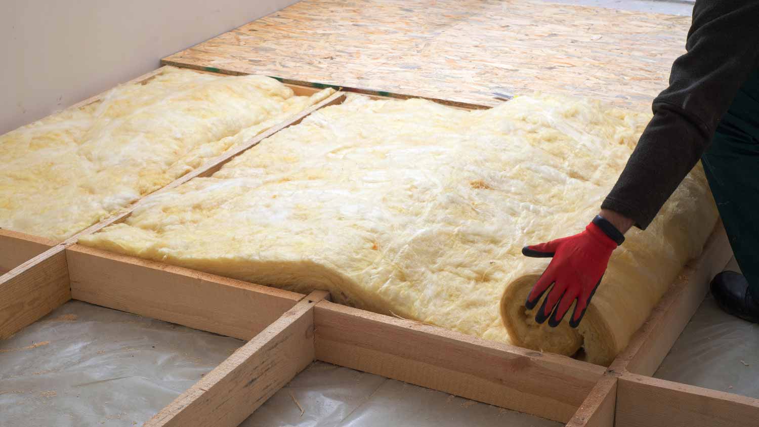 Man installing mineral wool insulation