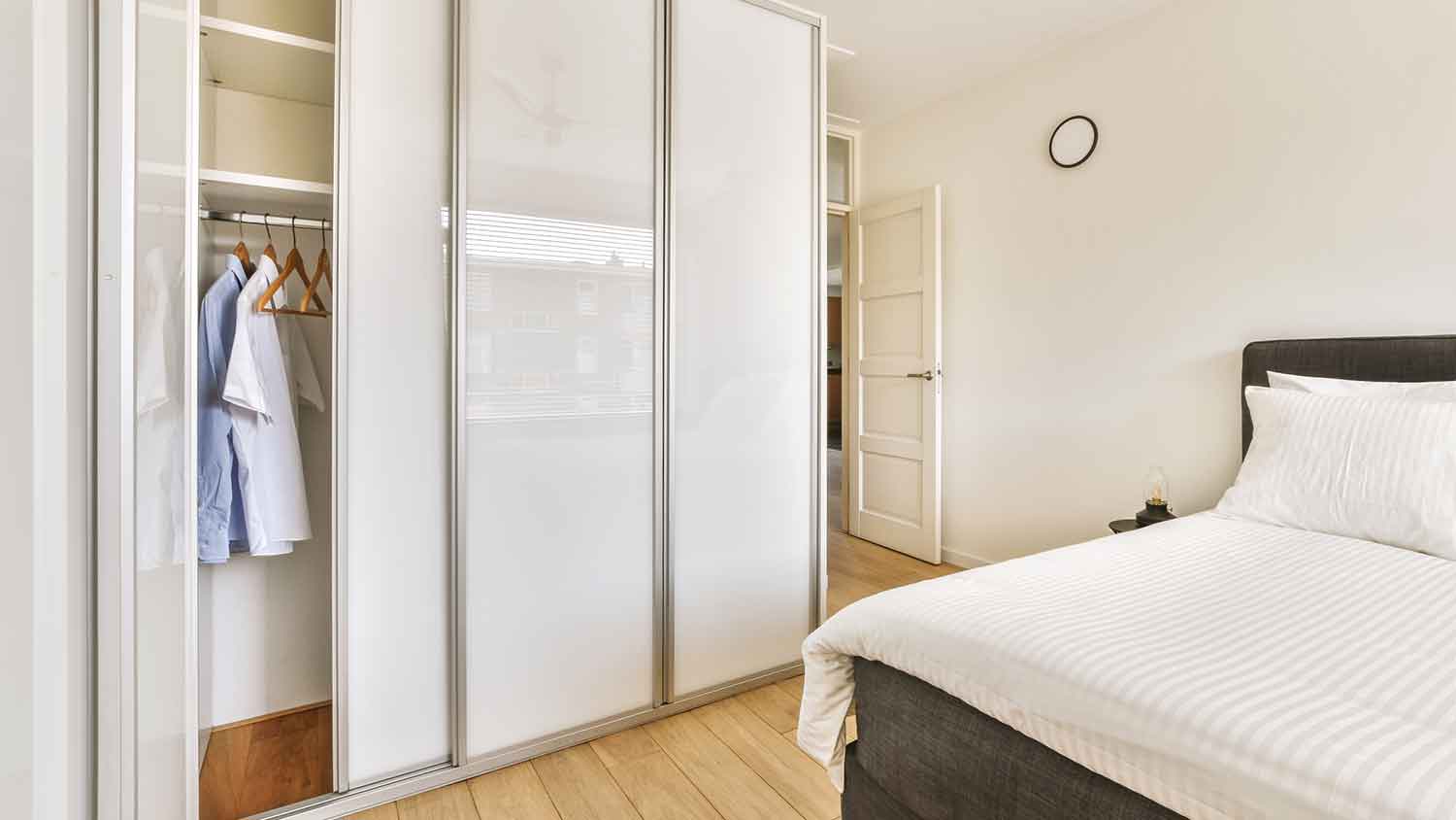 Bedroom closet with white sliding doors
