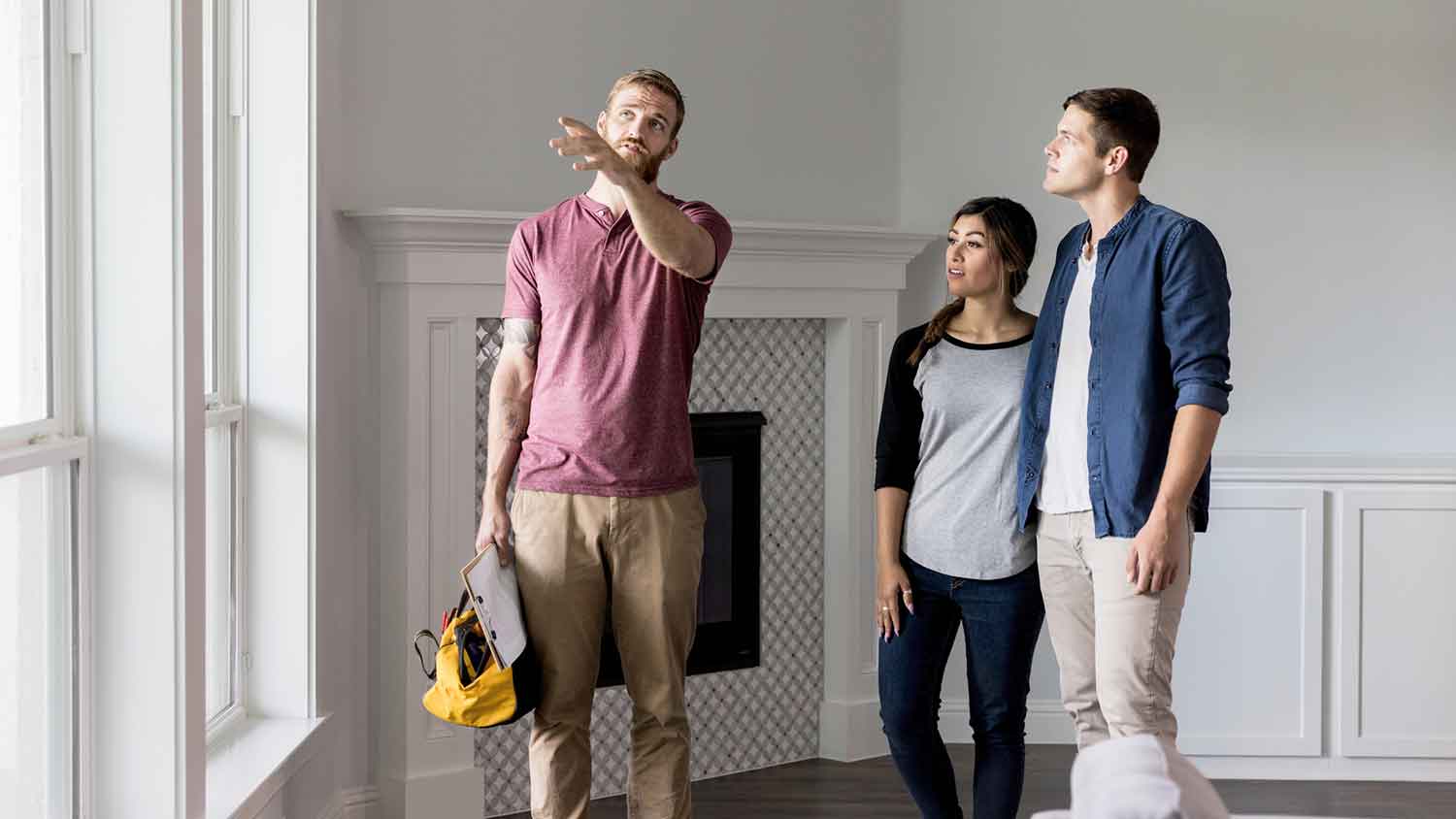 Contractor discussing home repairs with clients