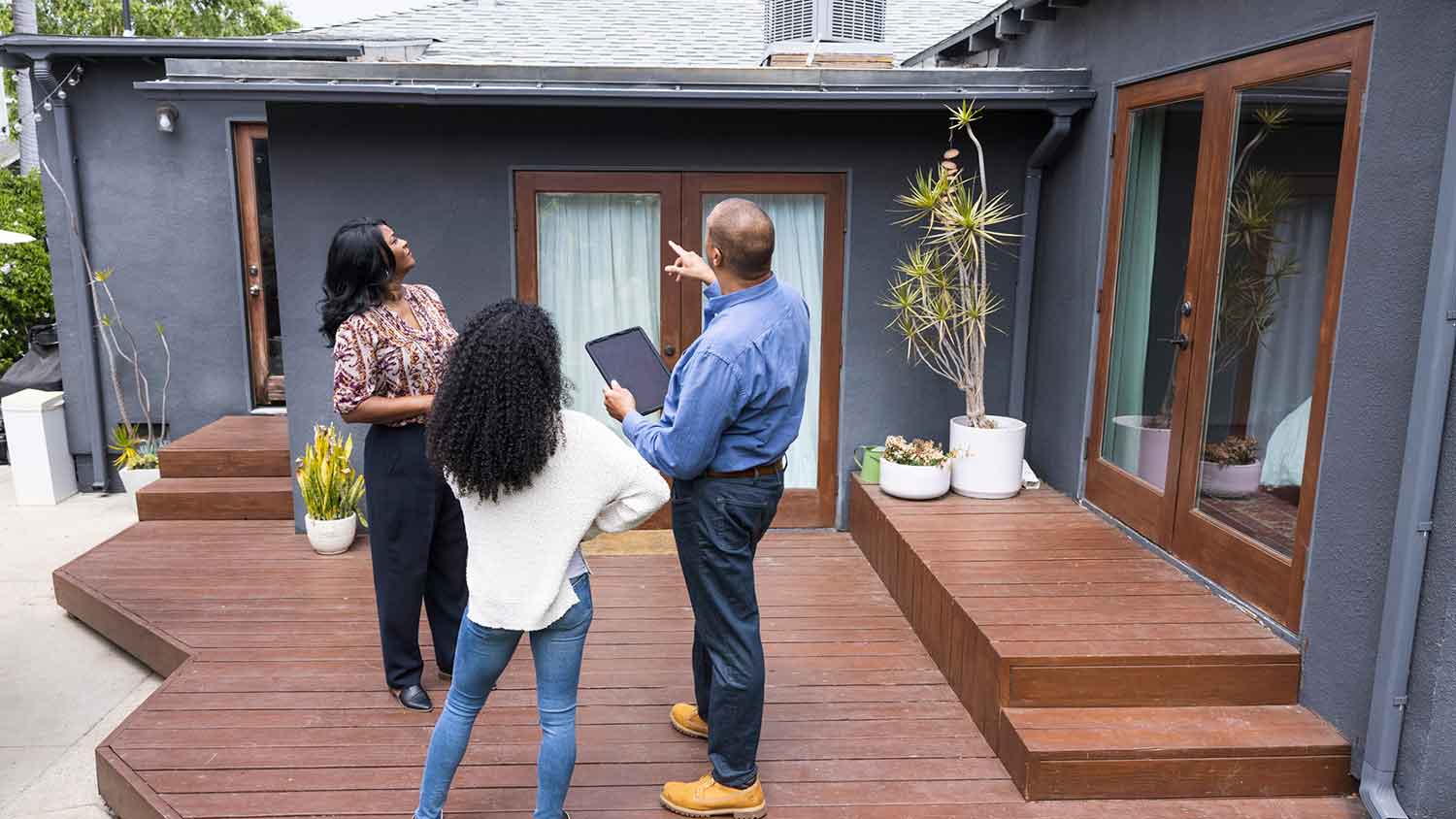 Inspector showing house exterior to a client