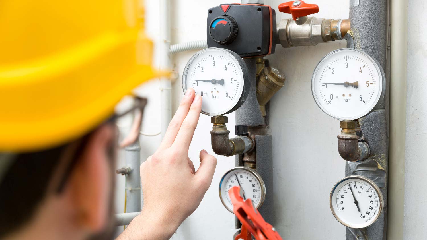 A professional checking the gas pressure