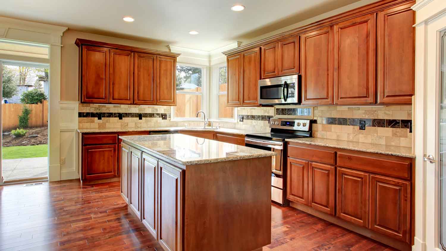 Classic kitchen design with red stained wooden cabinets