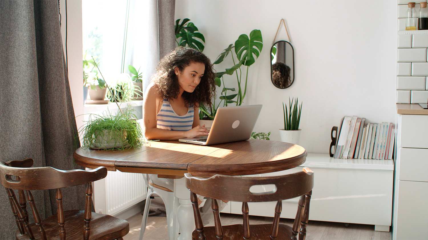 woman at home searching on laptop