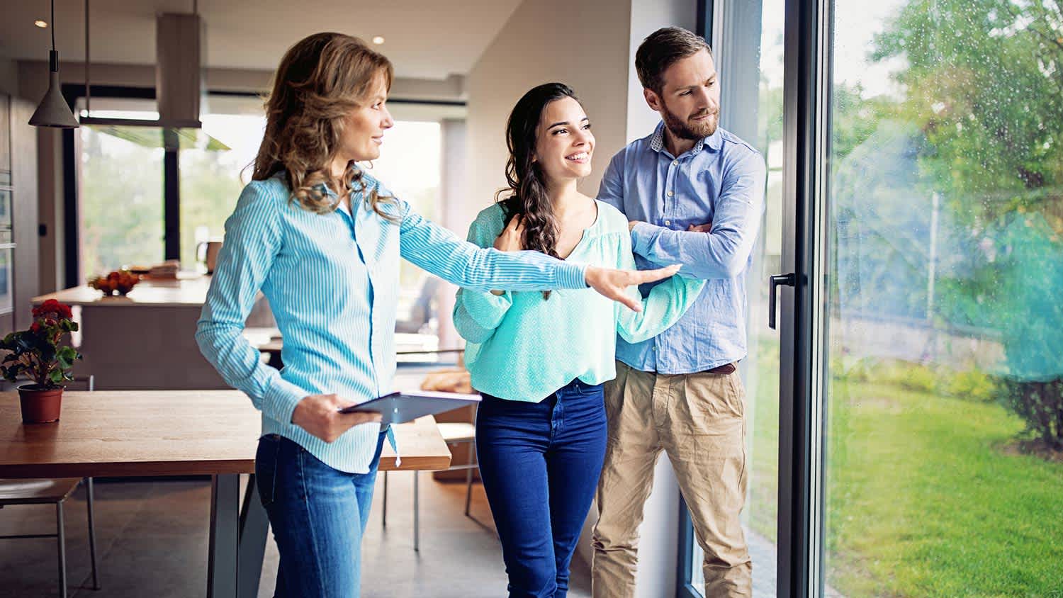 Home buyers look over house with inspector