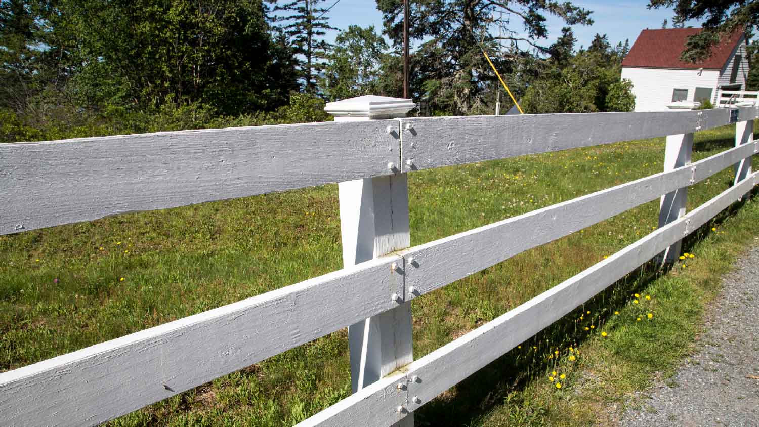 A white post and rail fence