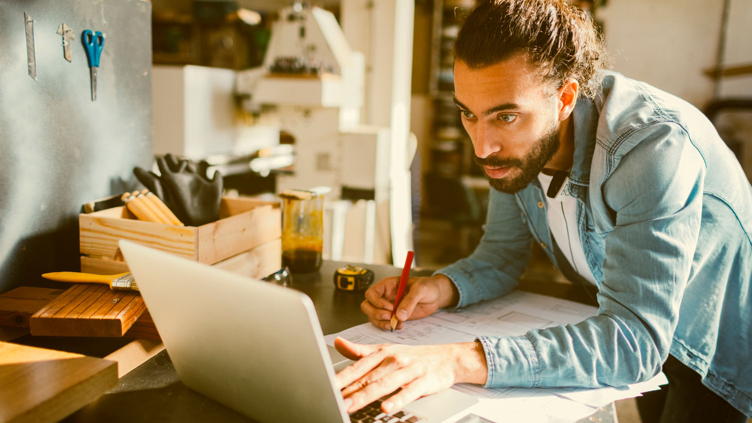A contractor using a laptop at his office
