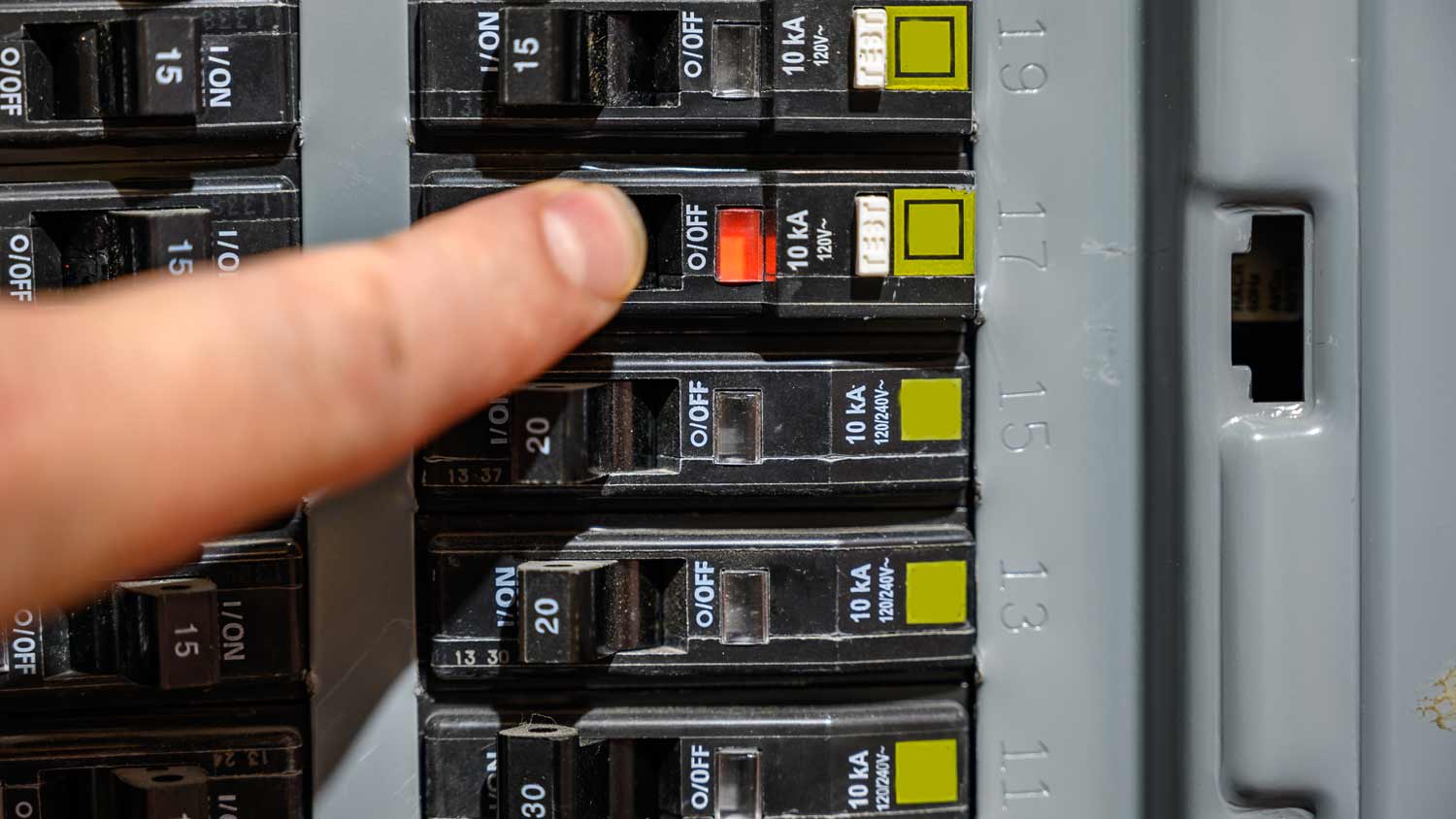 man shutting off electricity from control panel