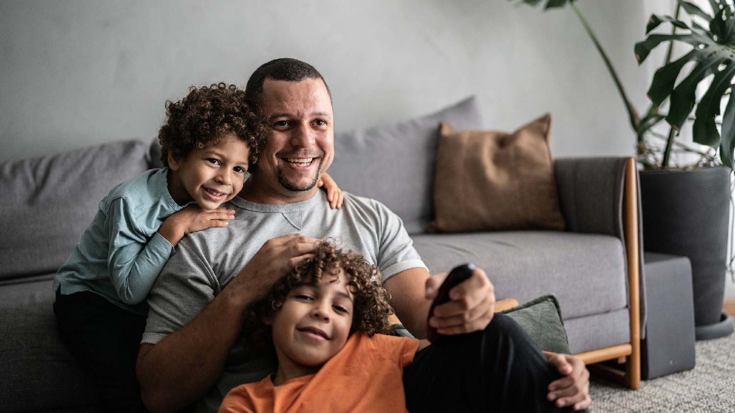 A father and his sons watching TV