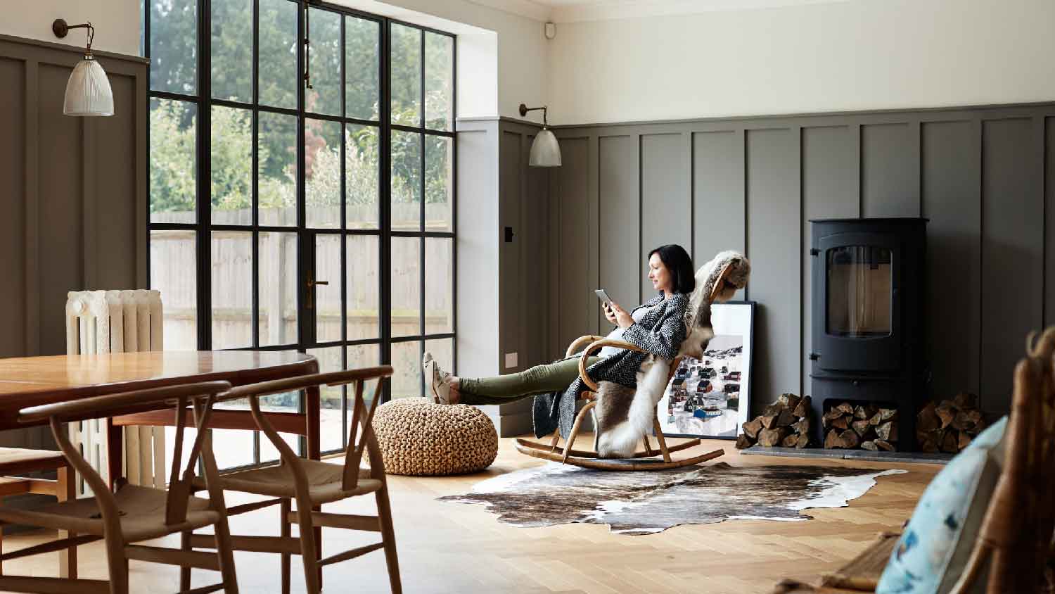 A woman enjoying her time while sitting on a rocking chair