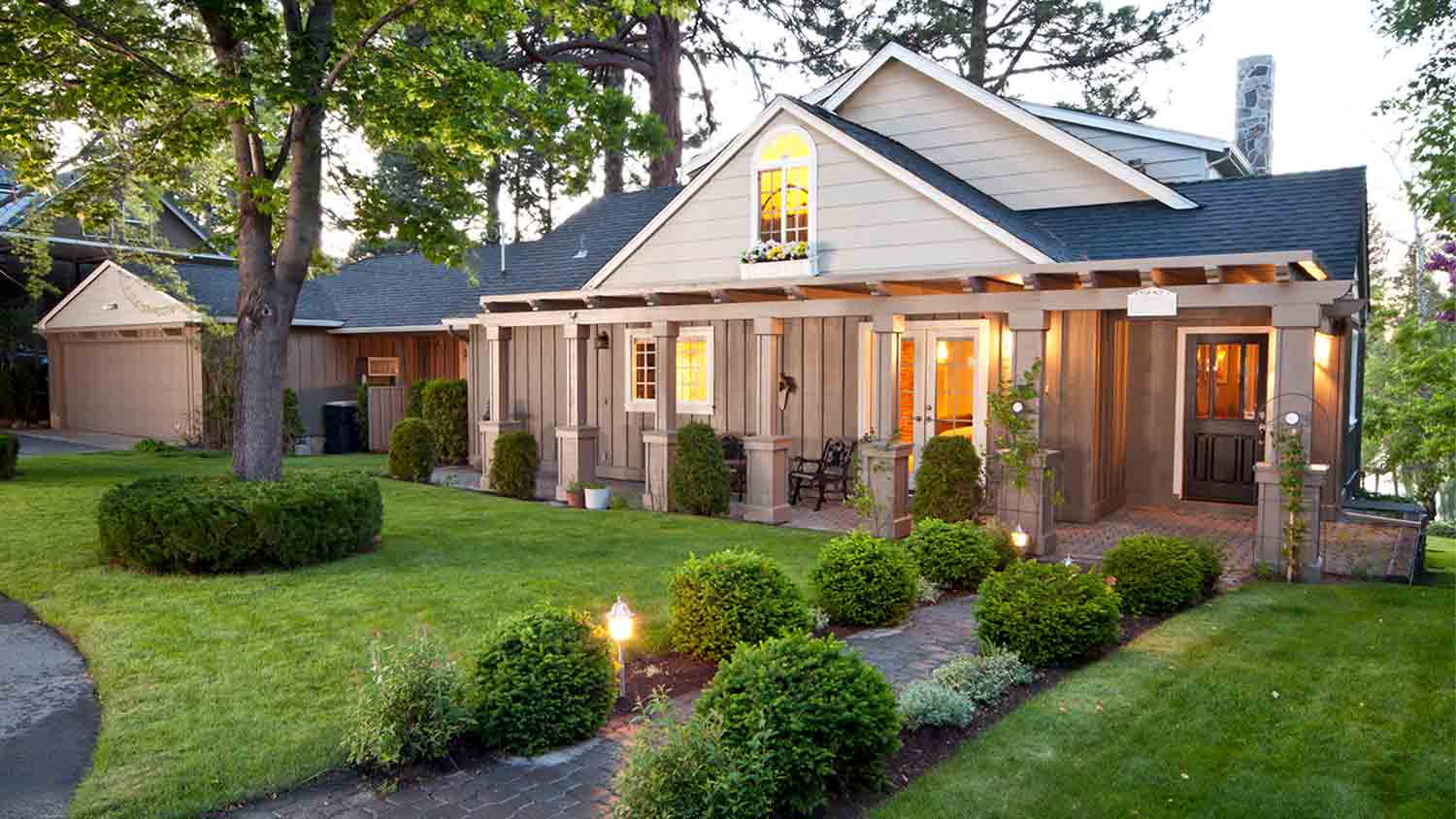 Home exterior with manicured lawn and landscape lights