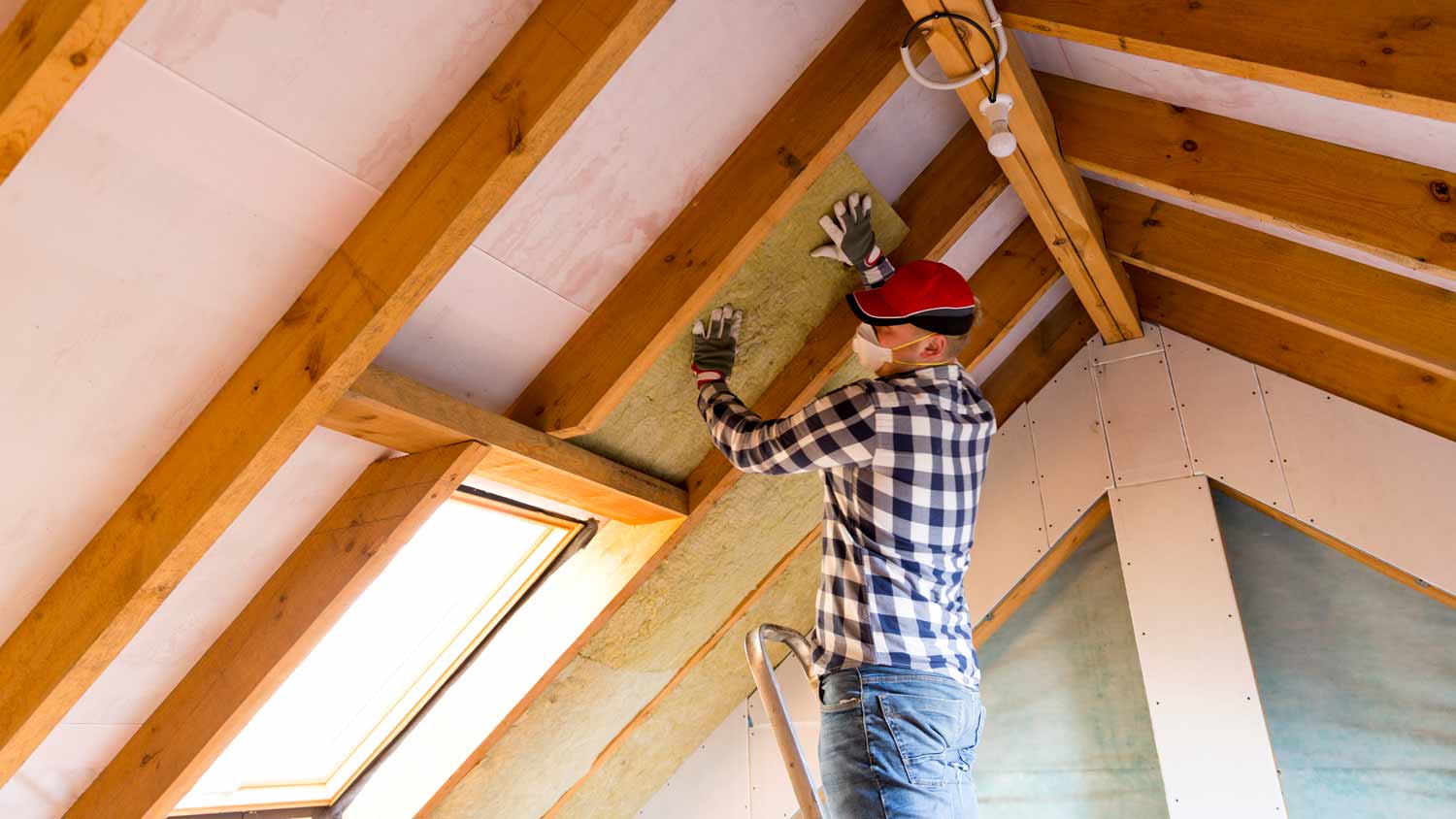 man installing thermal roof insulation