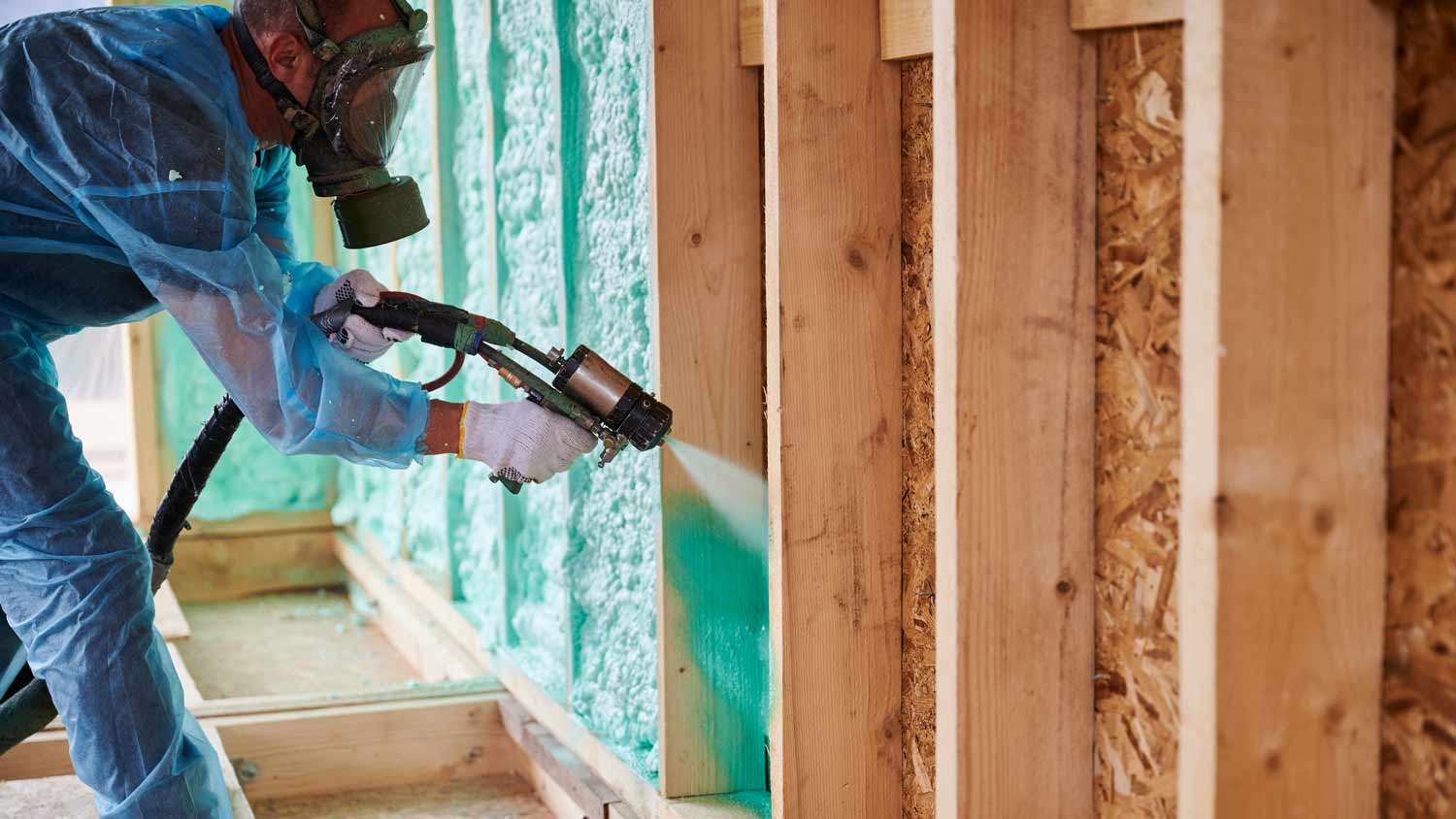 man spraying foam insulation