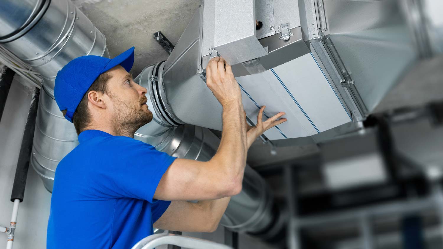 A professional inspecting ductwork