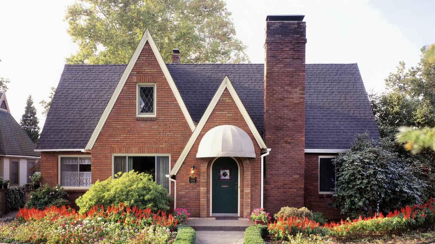 Cozy brick house with chimney and walkway