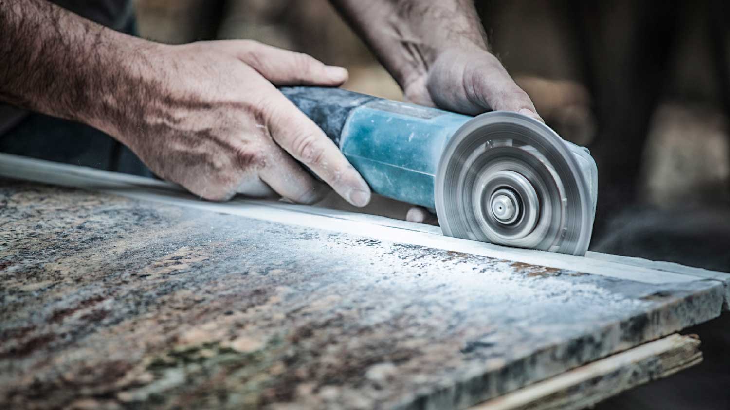 Close-up of a saw cutting a granite countertop