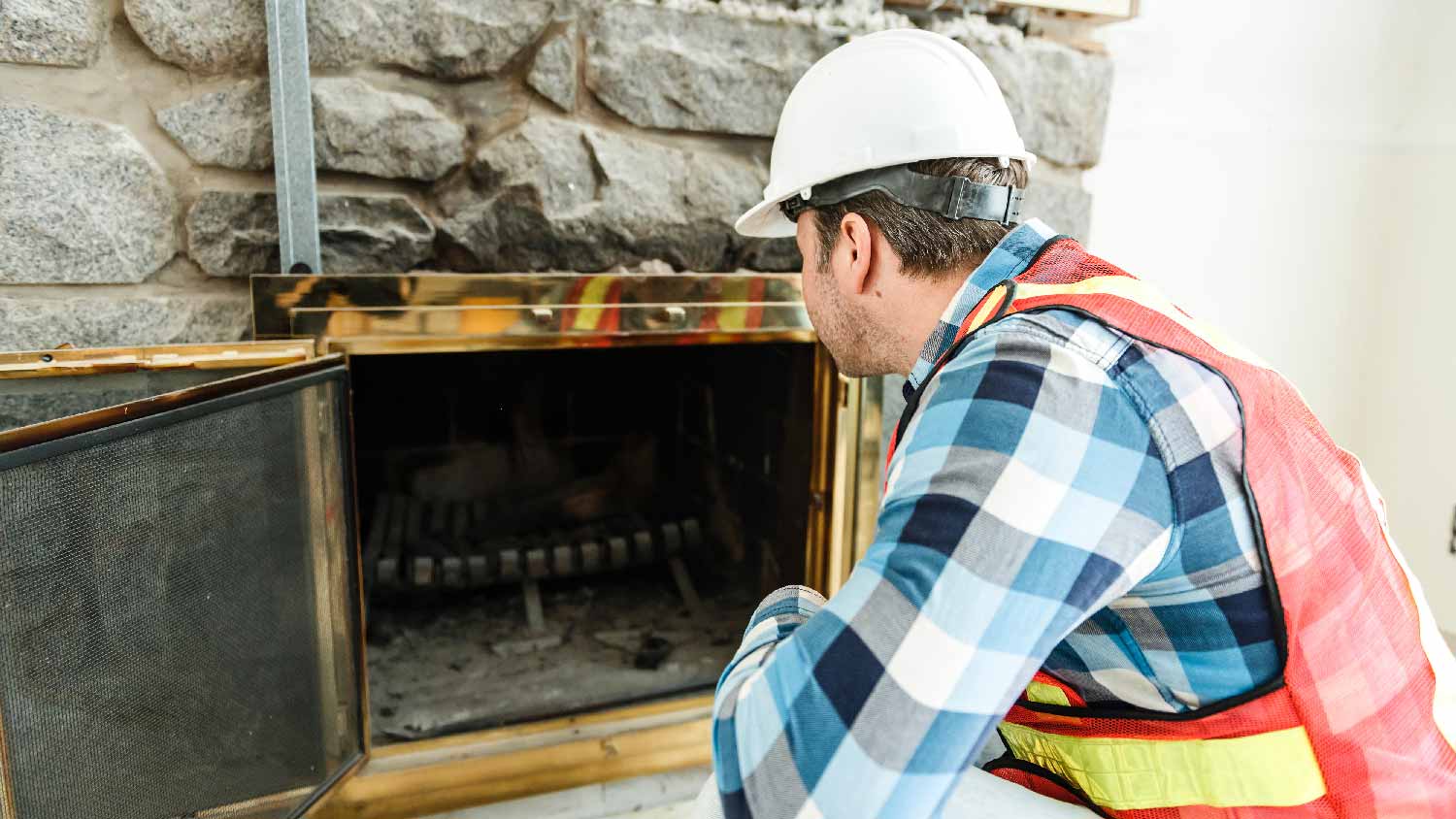 A person examining the fireplace