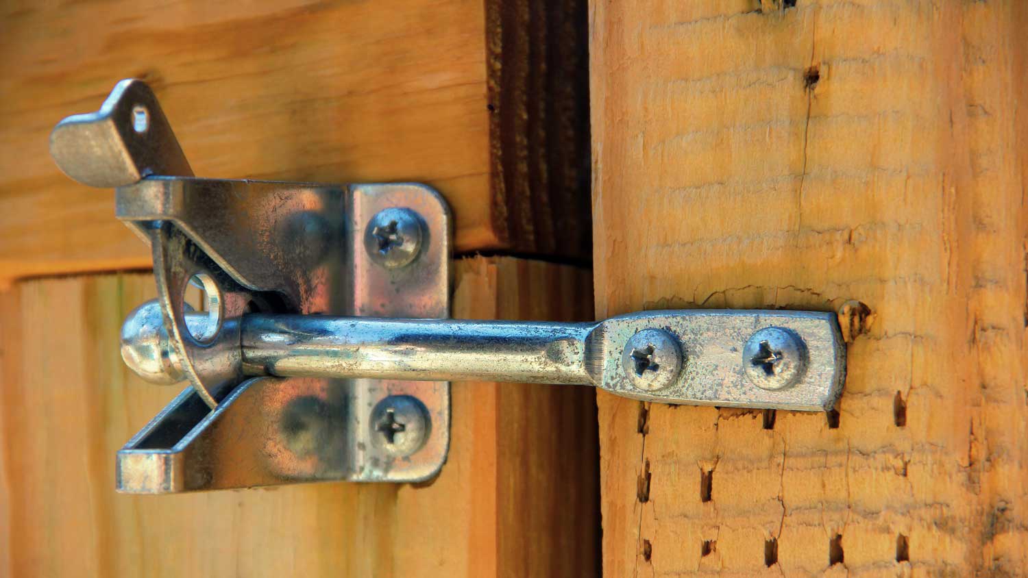 gravity latch on wooden gate fence
