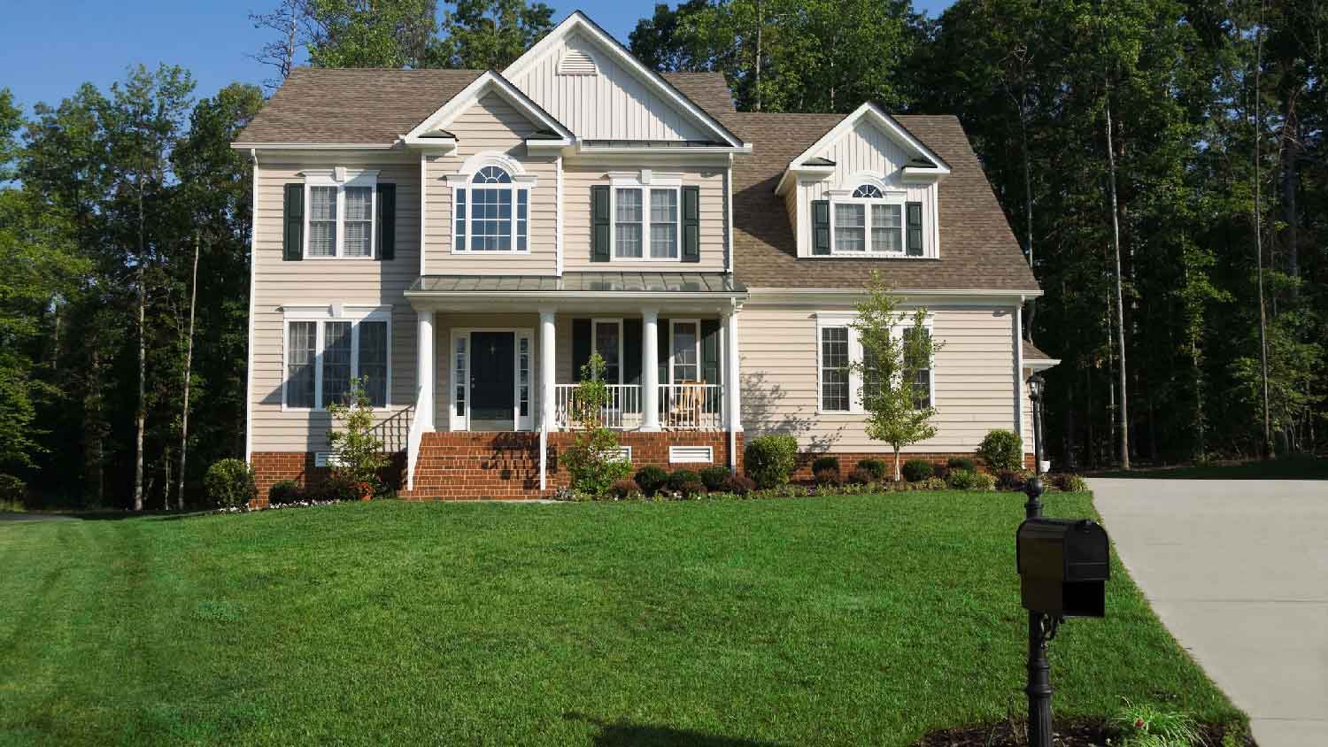 The exterior of a house with a great front lawn