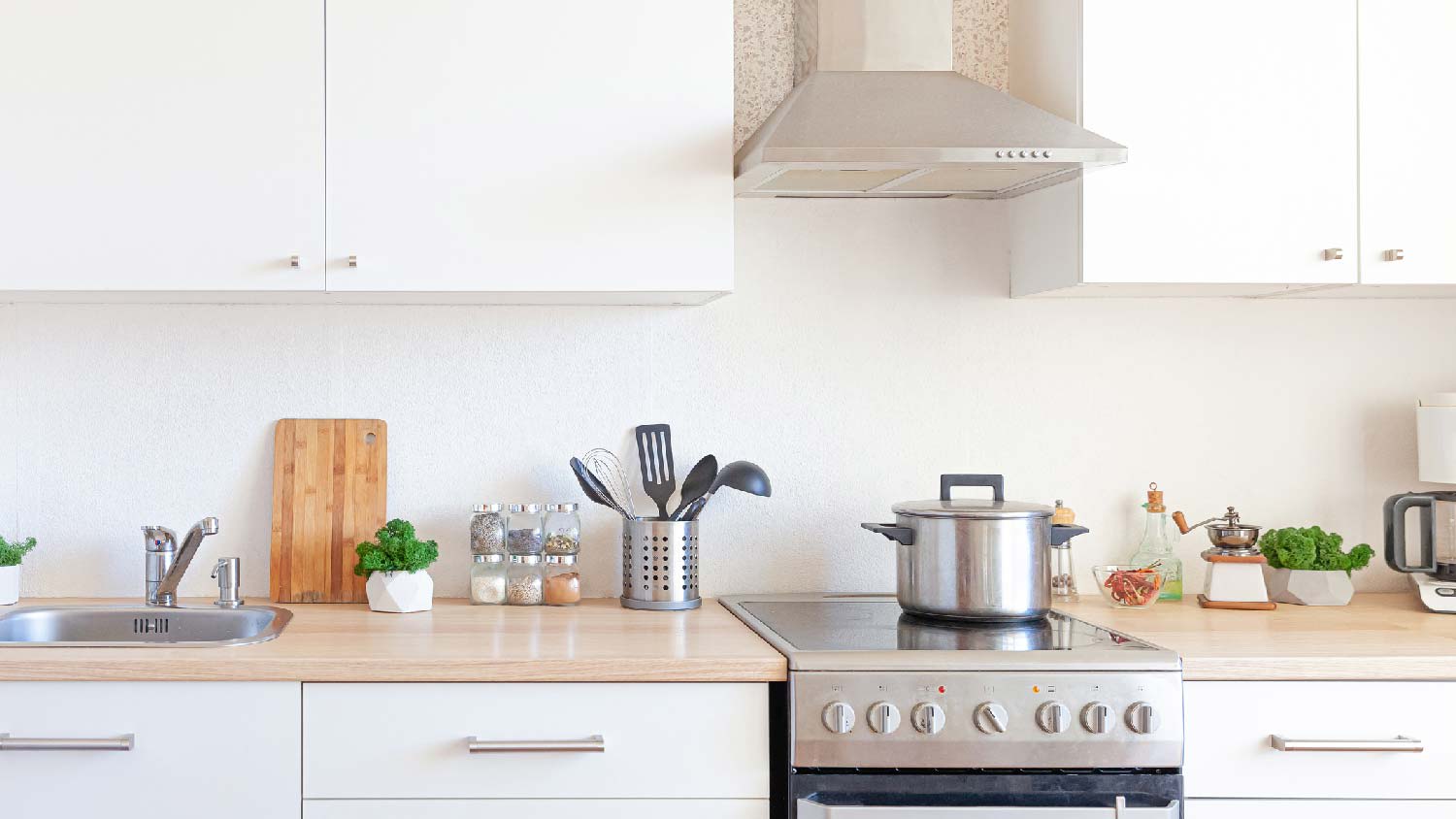 A minimalistic kitchen with a hood used as an exhaust fan