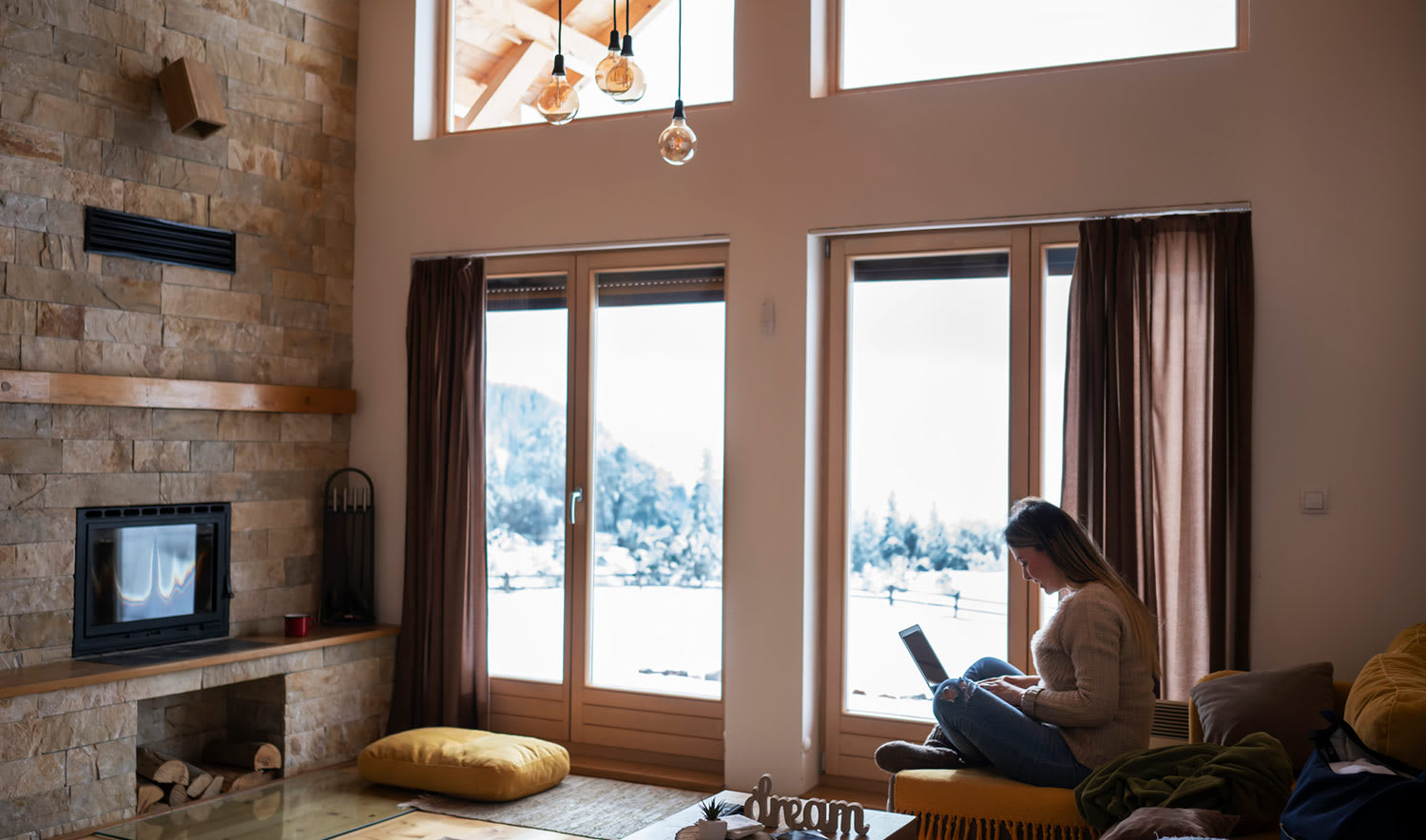 Woman in front of windows with winter scene outside