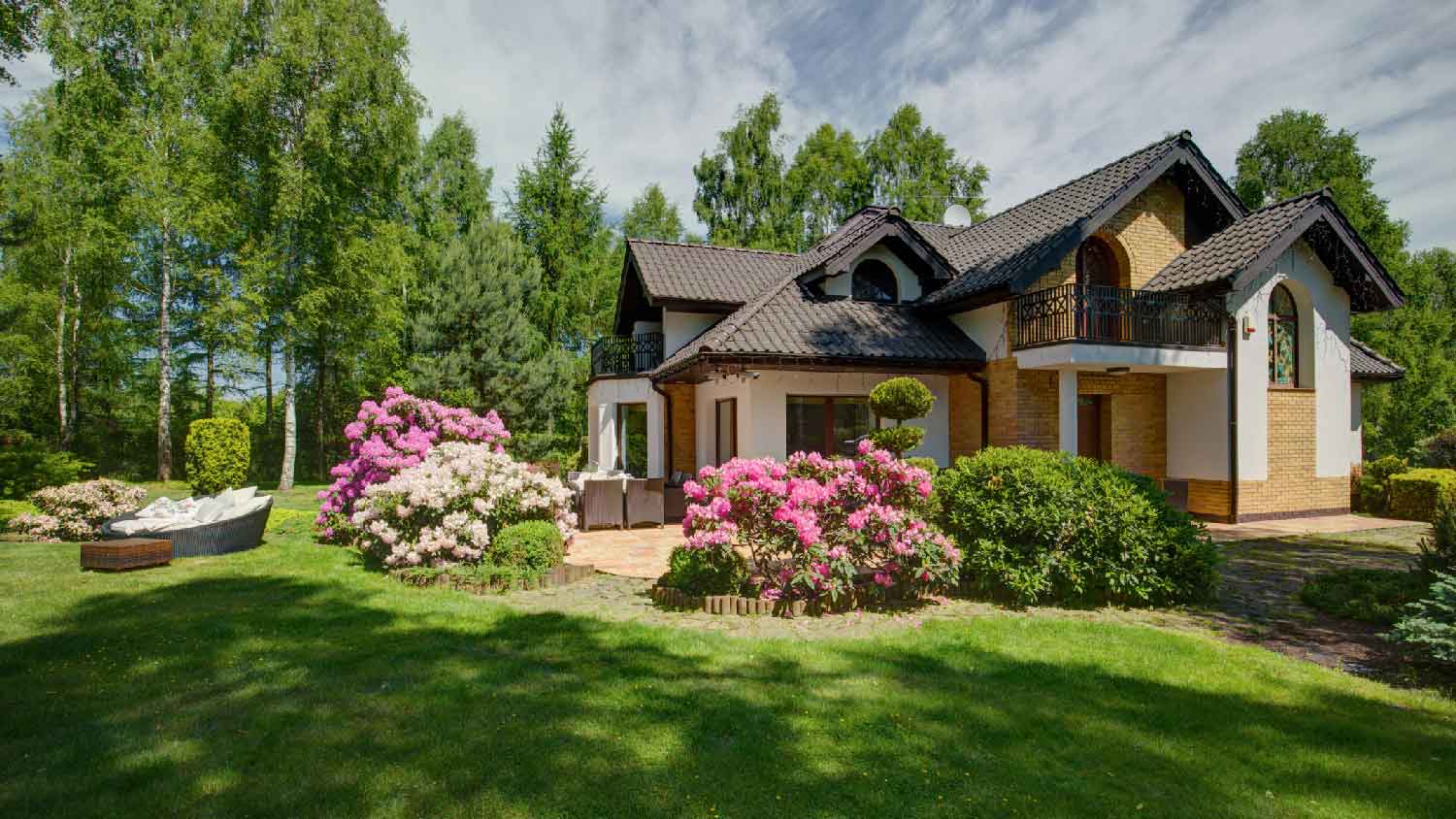 A landscaped yard with flower beds
