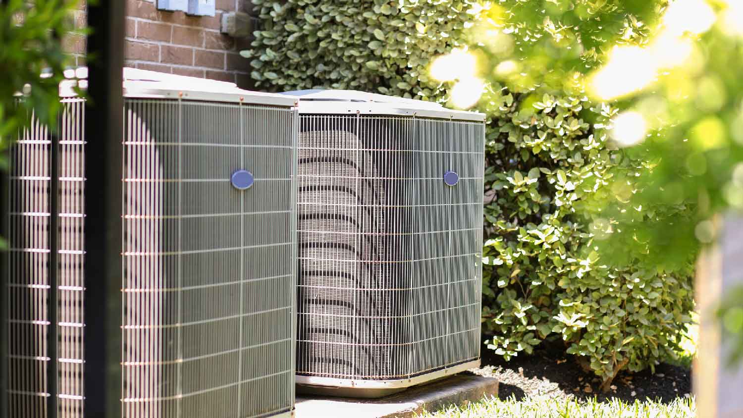 A HVAC system in the backyard of a house