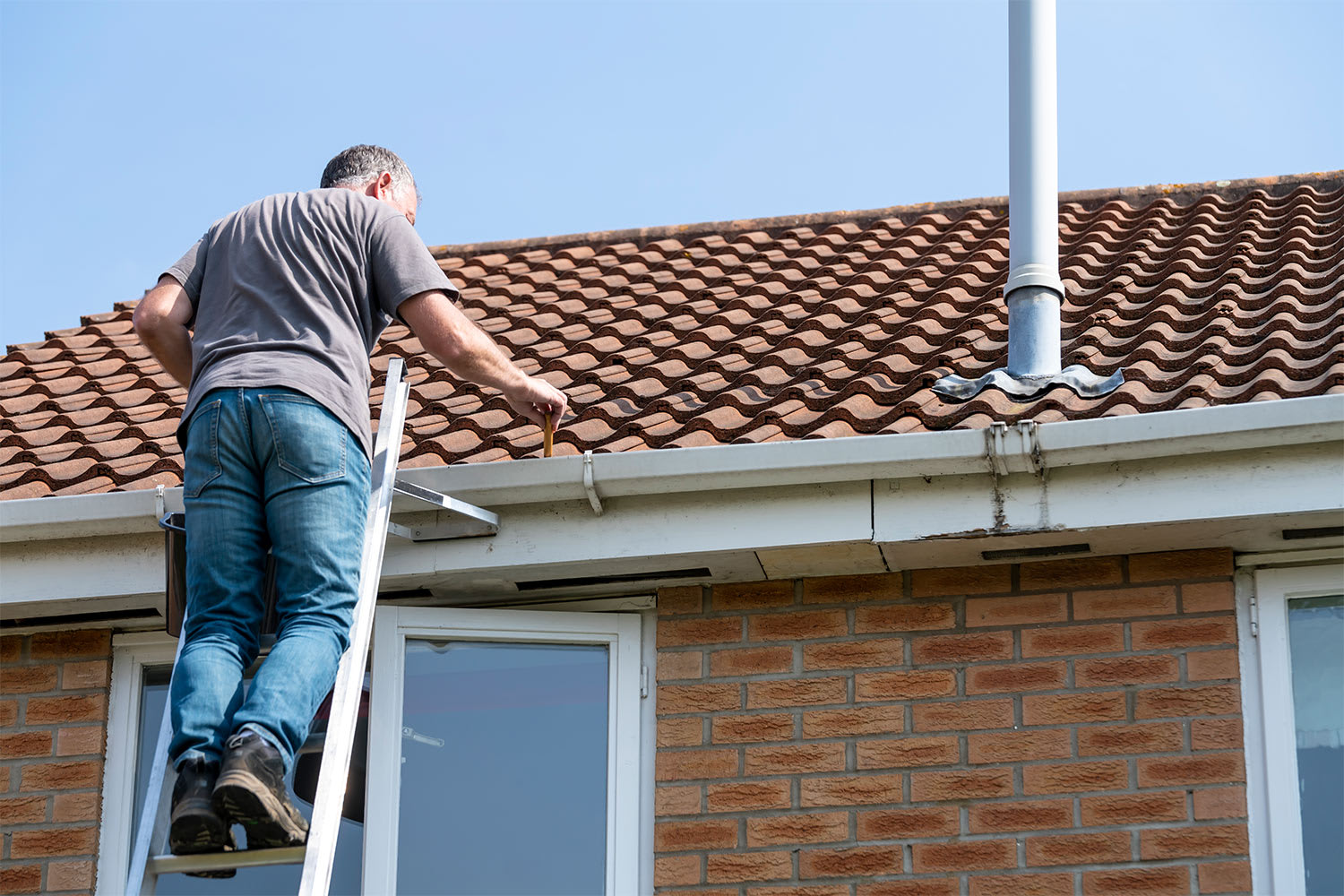 man cleaning roof