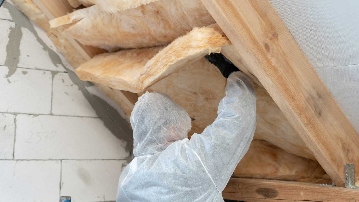 A professional sealing an attic