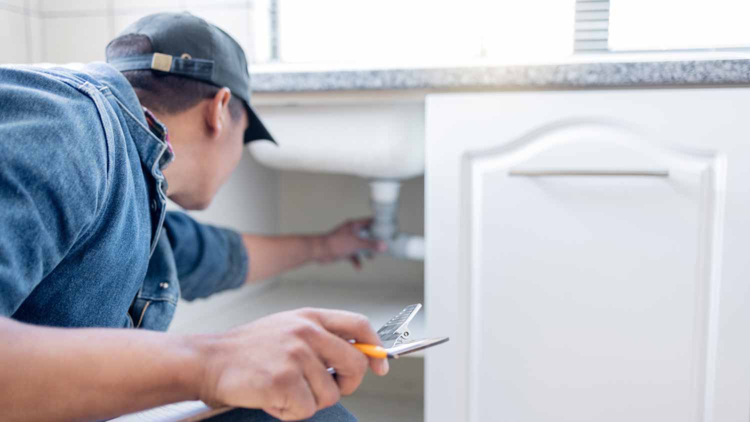 Man checking under the sink