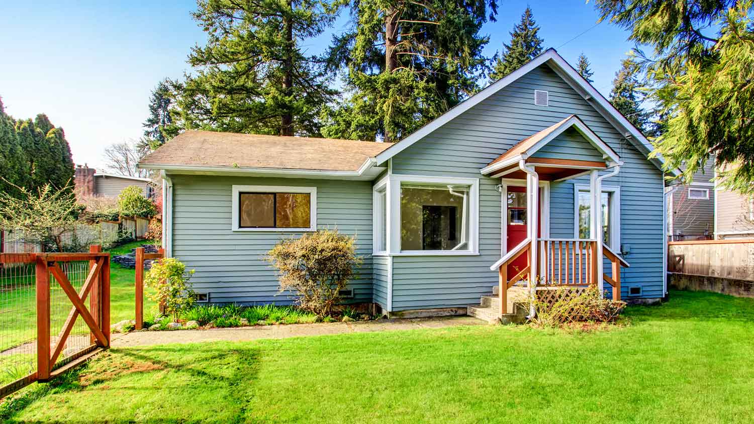 House exterior with small front porch and wooden fence