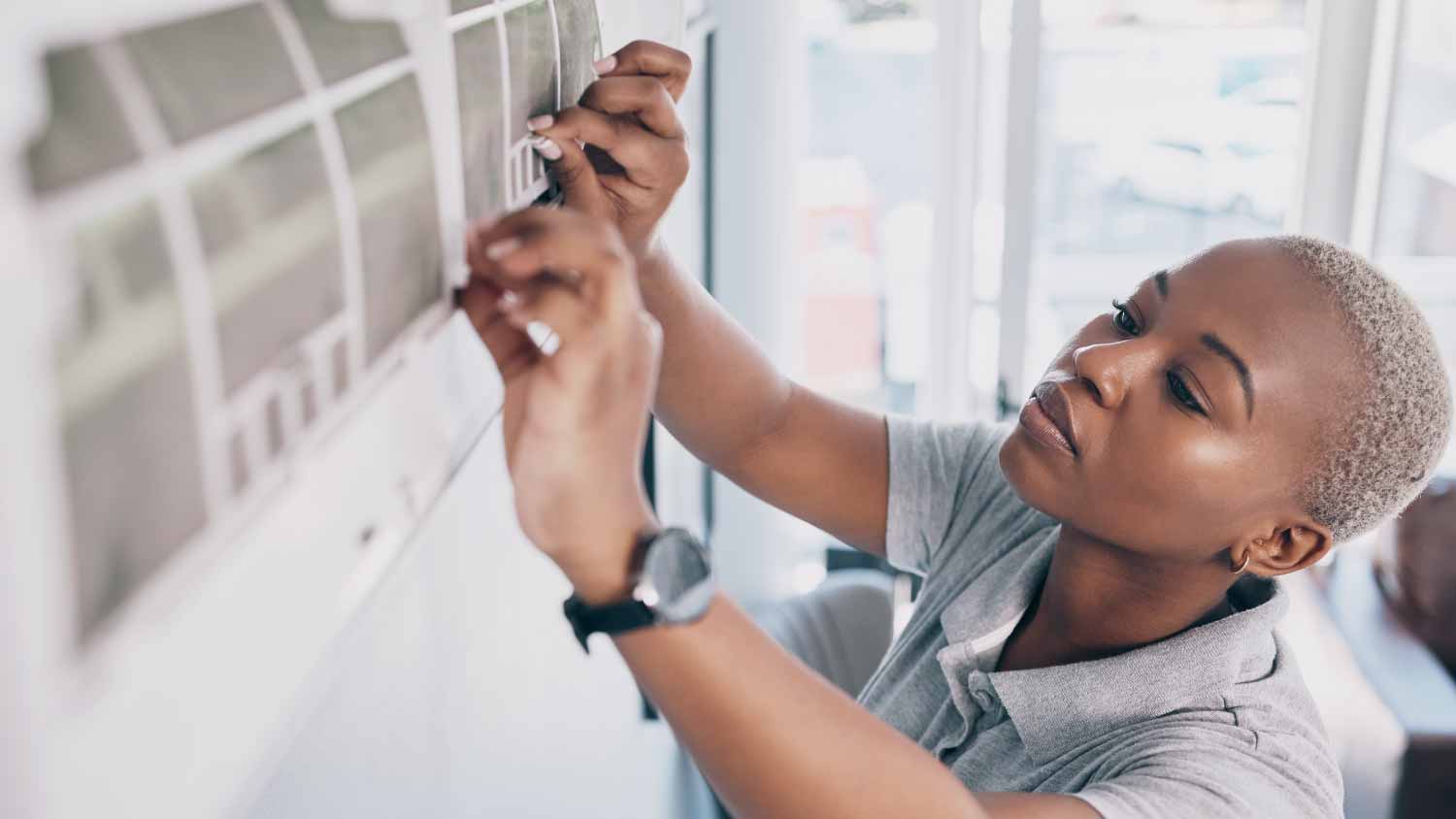Woman checking air conditioning
