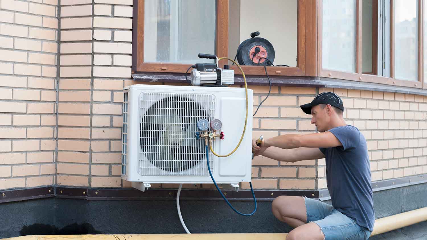 HVAC professional installing residential heat pump