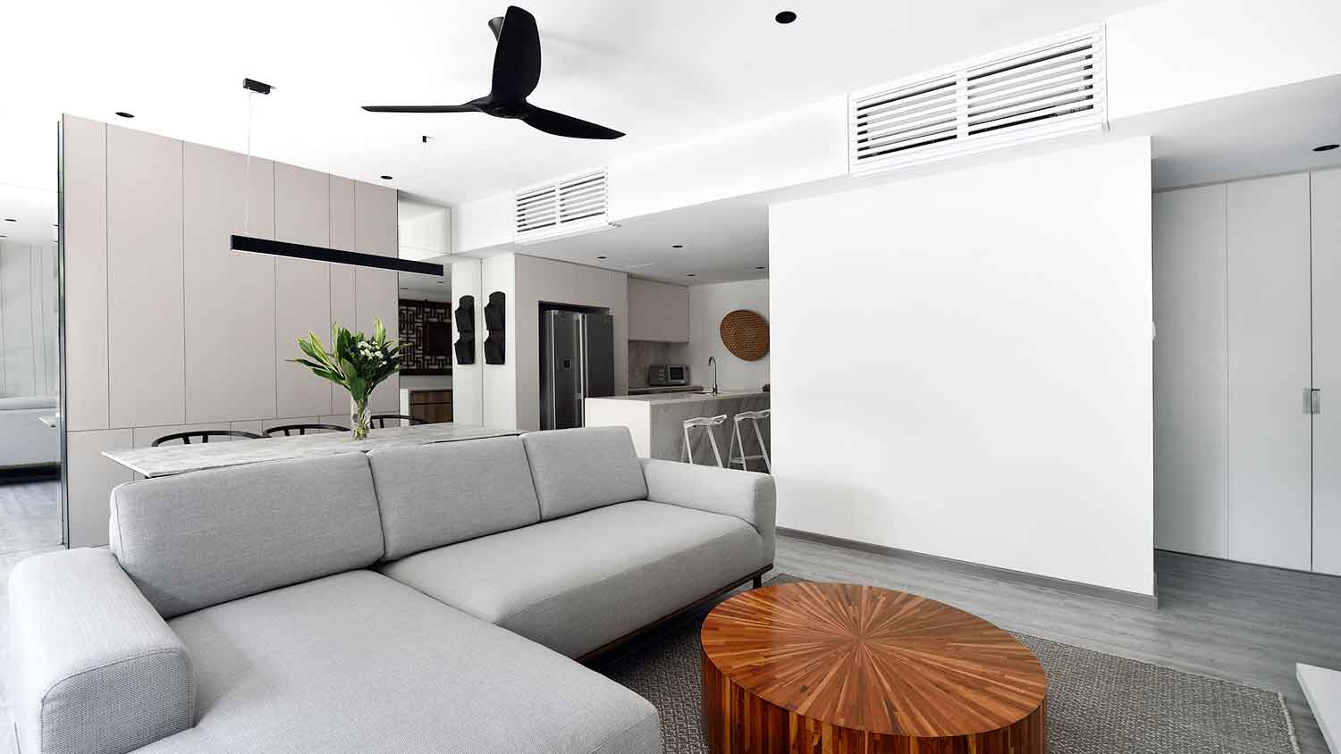 Contemporary condominium with air ducts and ceiling fan