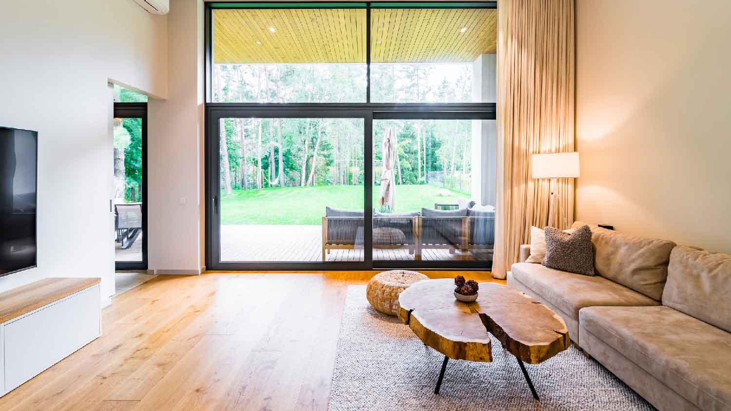 The interior of a living room with views to the backyard