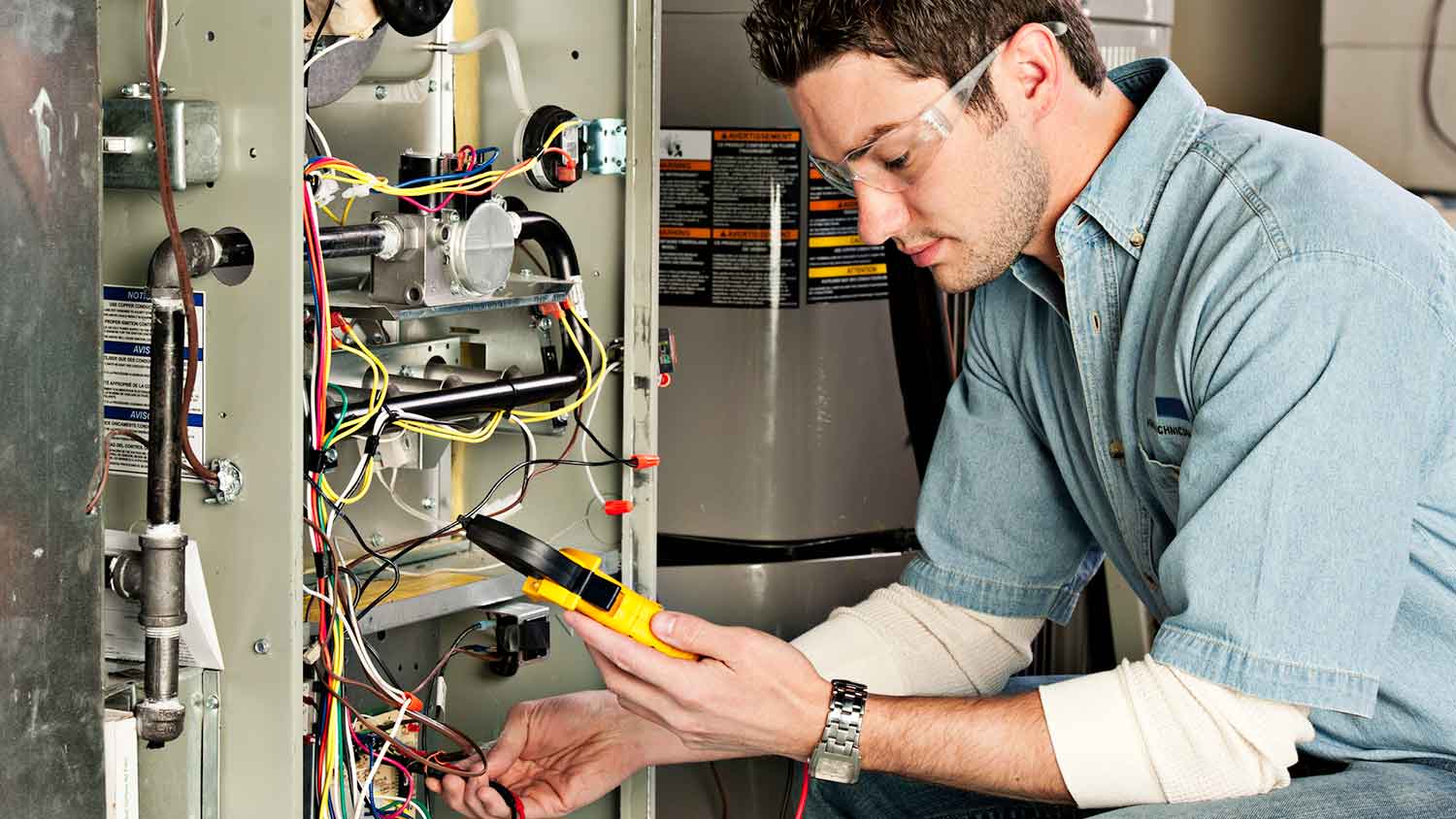 Technician inspecting residential furnace