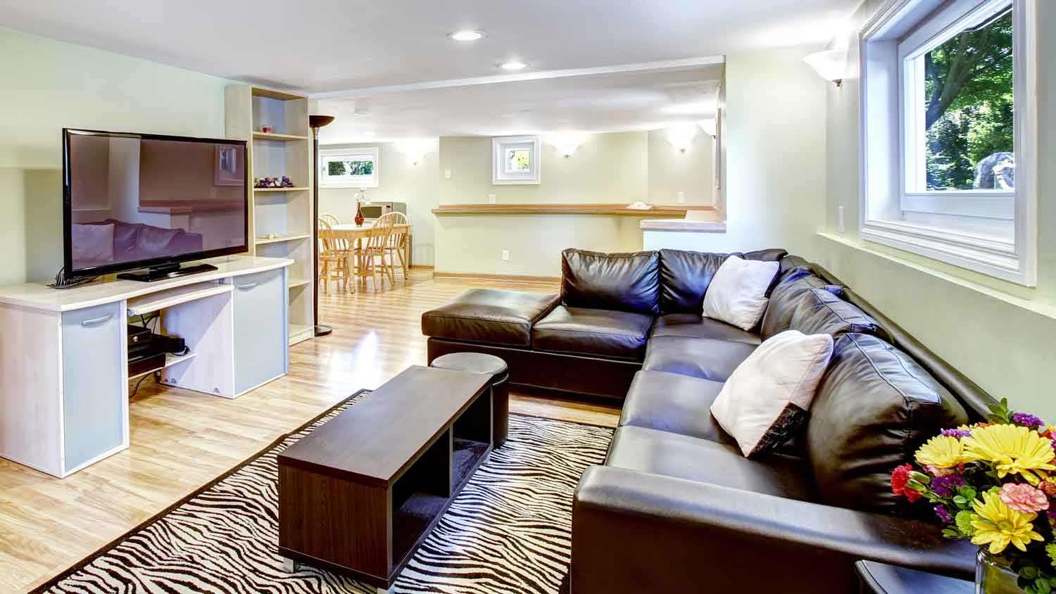 An open-space living room in a house’s basement