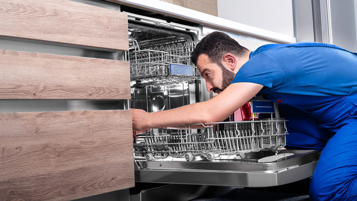 Man repairing dishwater