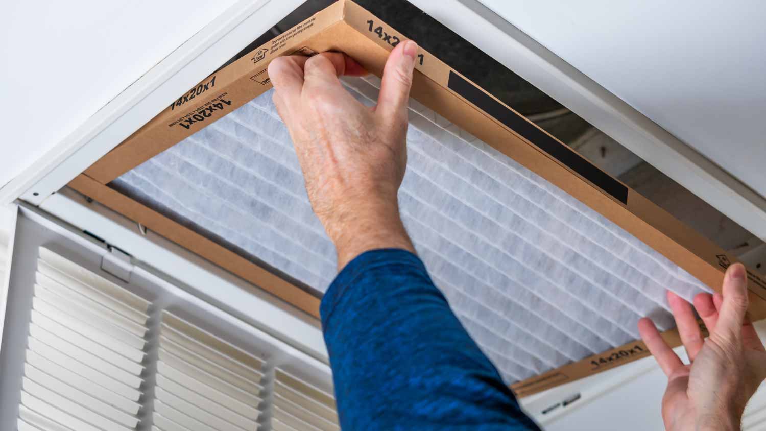 Man replacing dirty HVAC air filter