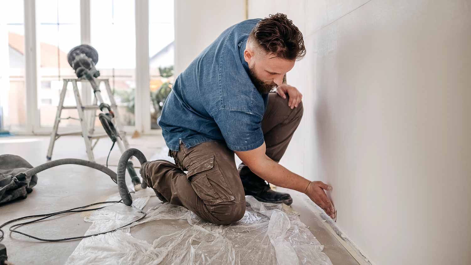 Worker installing drywall