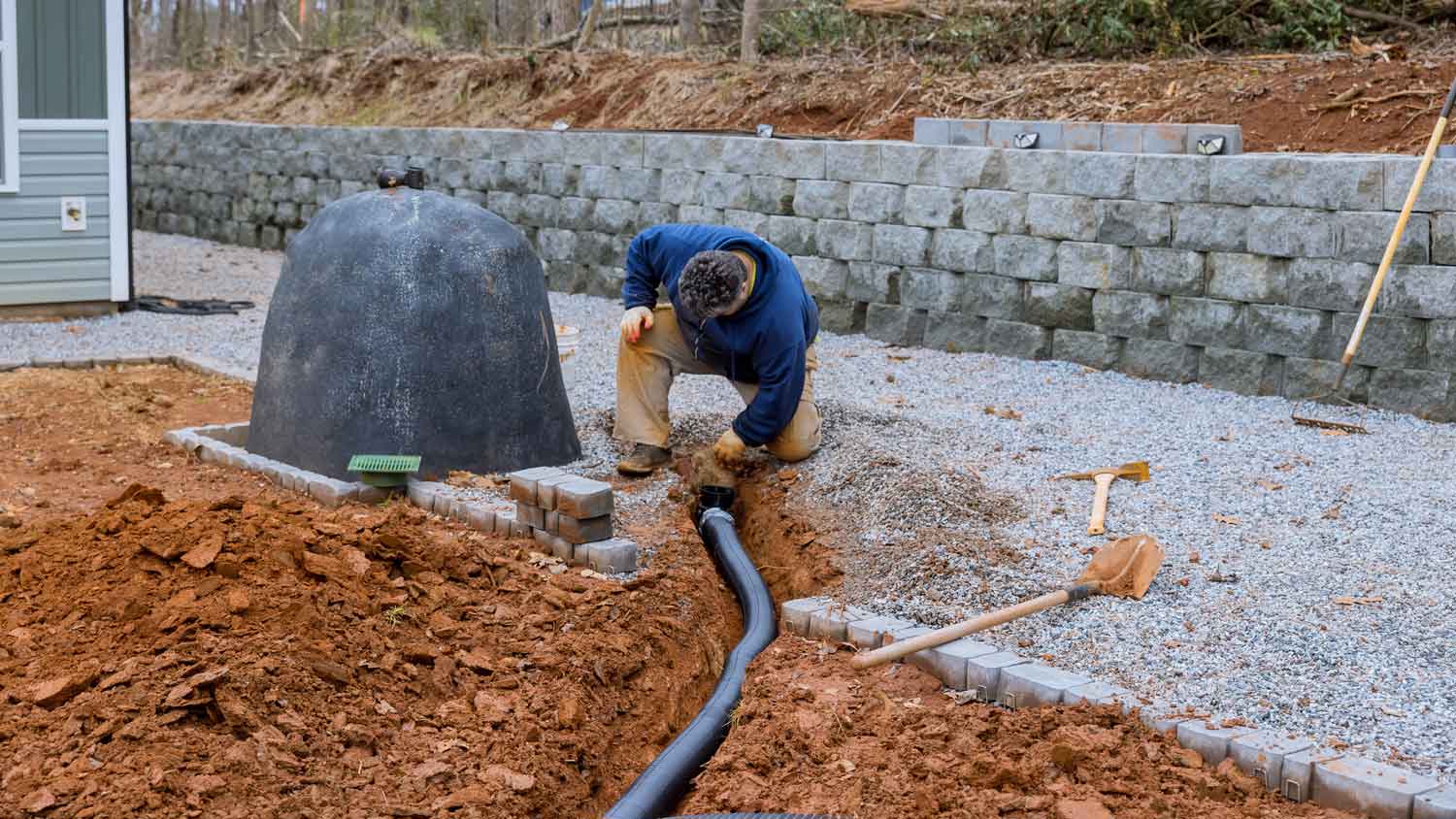 A person installing a sewer line