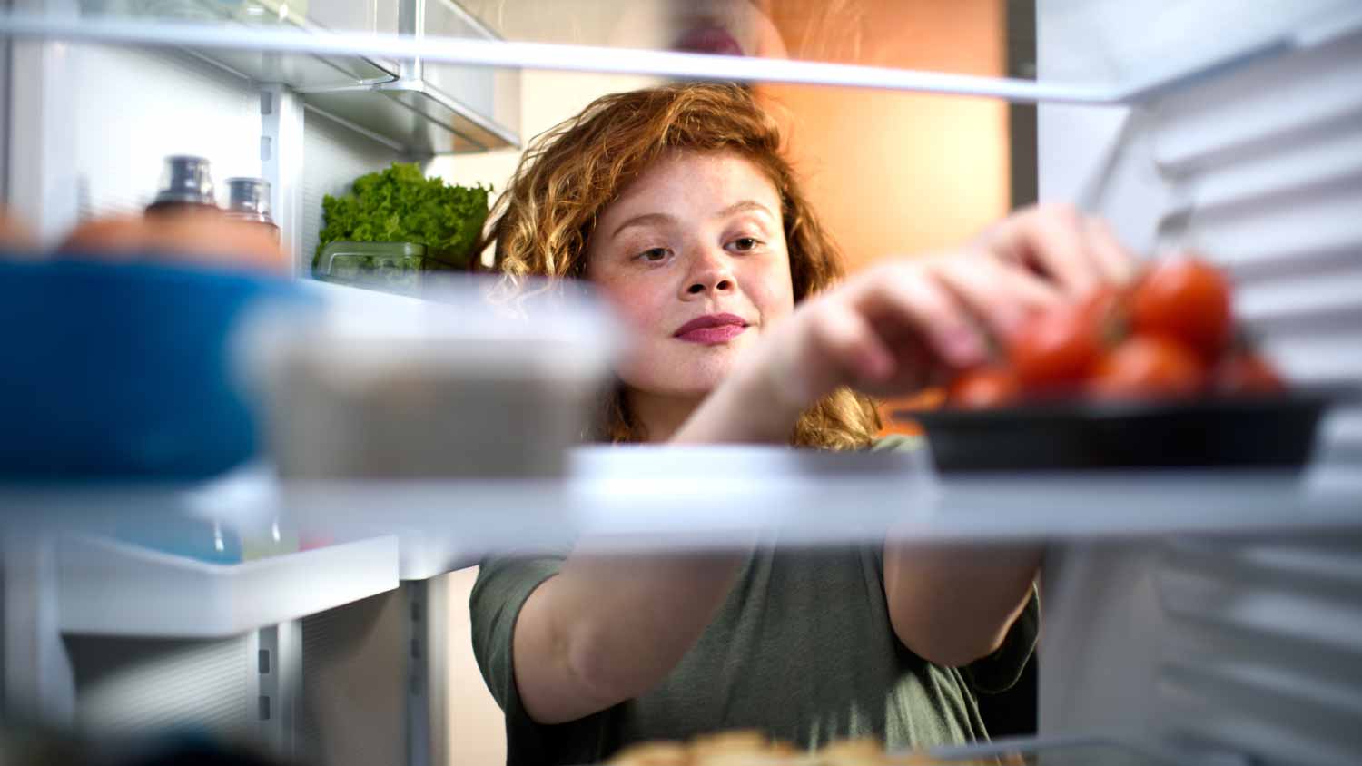 Woman looking inside the refrigerator
