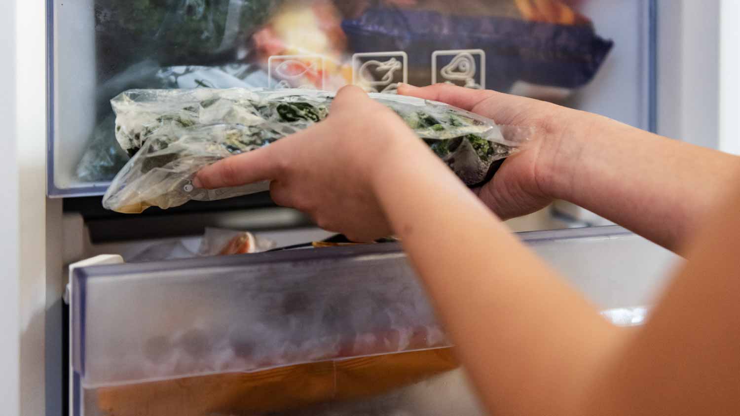 Woman taking raw food from refrigerator