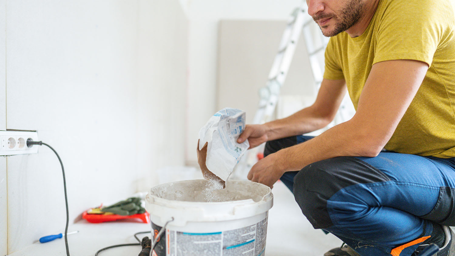 man mixing drywall mud