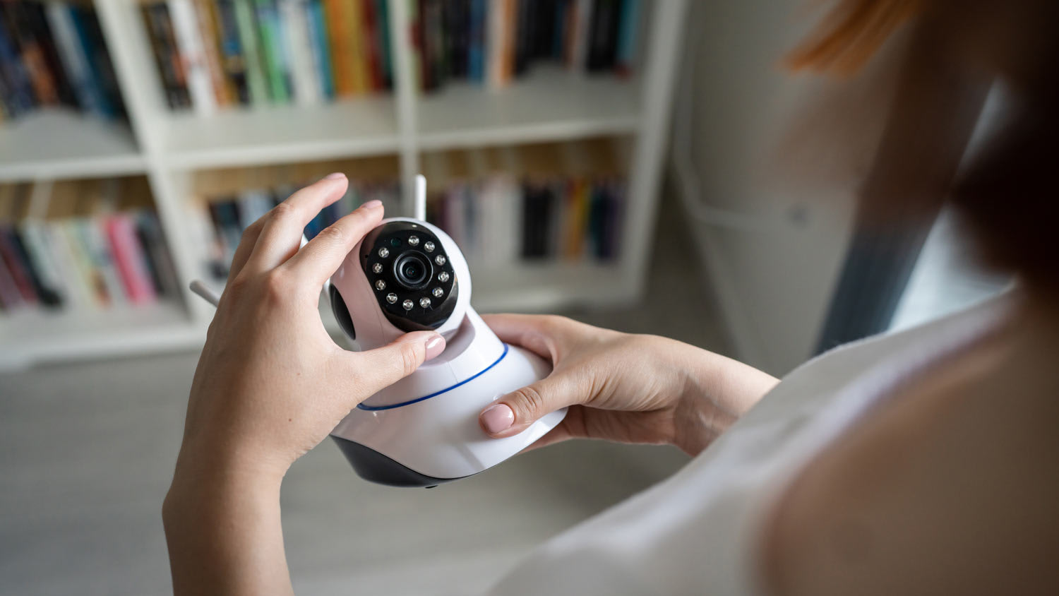 woman holding home security camera