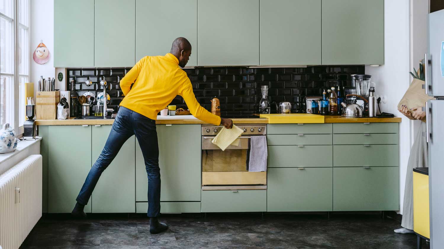 A man doing chores in the kitchen