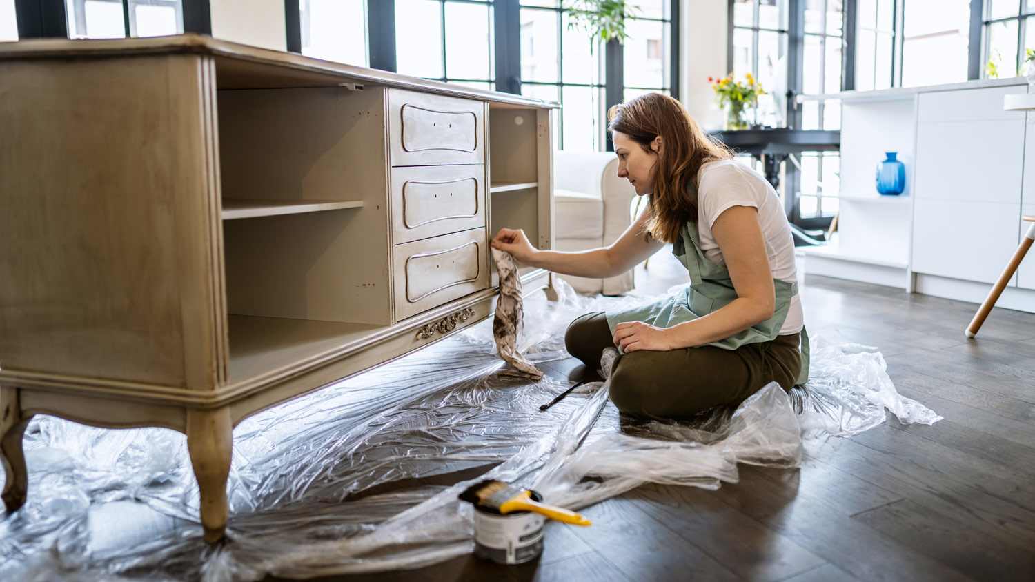Young woman repairing an old furniture