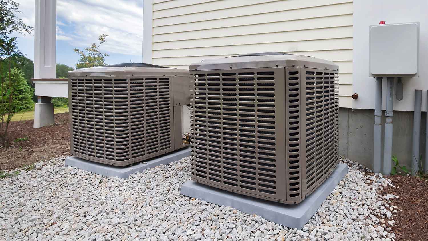 Air conditioner units sitting outside of the house
