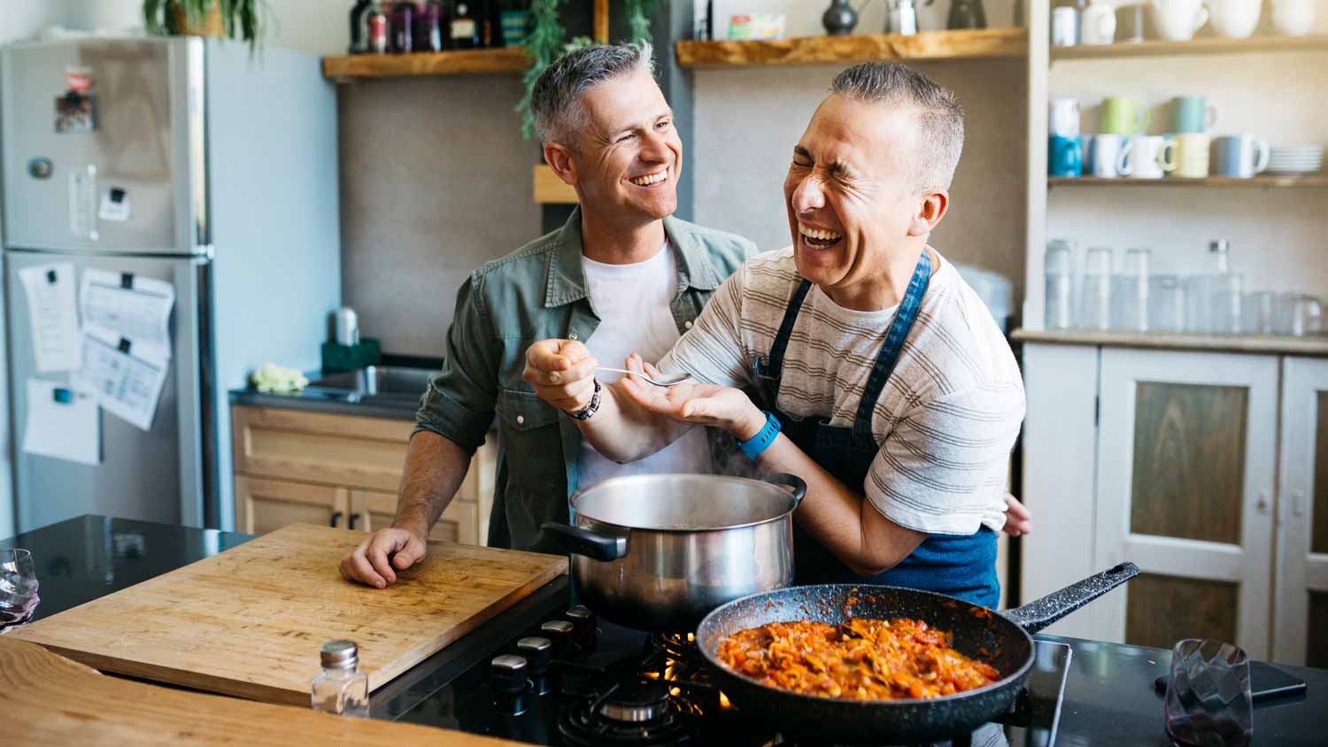 A couple cooking together in the kitchen