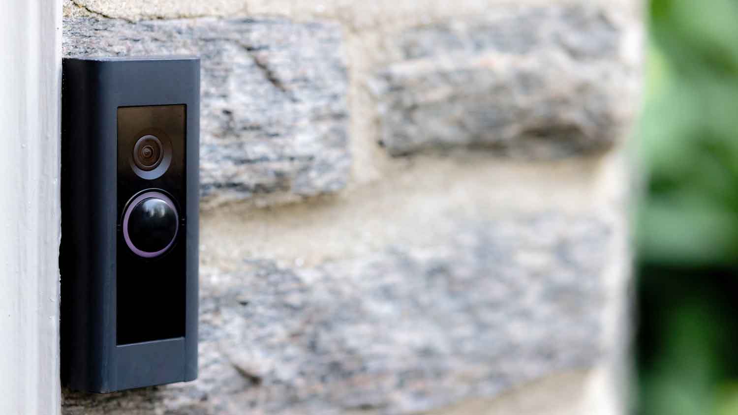 Doorbell camera installed on a stone wall